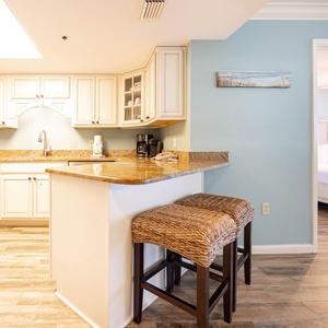 Prepare meals in this charming kitchen, featuring stylish countertops and seating at the breakfast bar