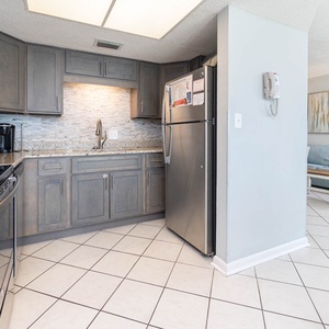 This kitchen features stainless appliances, granite countertops, and a cozy dining area perfect for meals