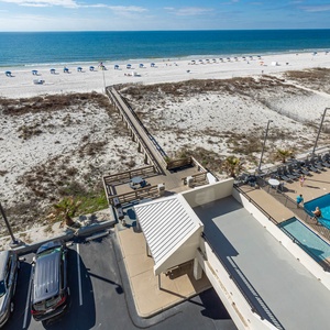 This stunning view showcases a pool area with lounge chairs, inviting guests to relax and enjoy the serene atmosphere