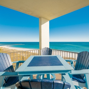 Balcony seating offers a serene view of the tranquil gulf and white sand beach, perfect for relaxation
