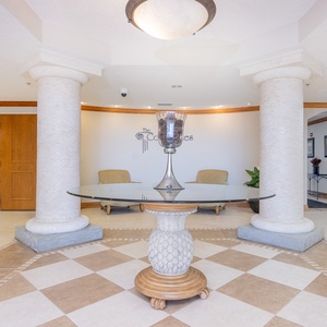 Step into a welcoming lobby featuring elegant columns, stylish decor, and easy access to your beachfront getaway