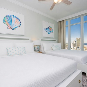 Wake to a breathtaking sunrise in this queen guest suite with two cozy beds and expansive views from the windows