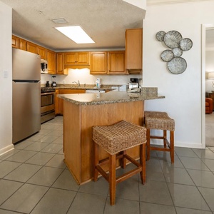 Two stools invite you to chat or snack at the kitchen breakfast bar while preparing meals with ease