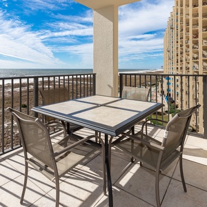 Balcony seating overlooks the beach, inviting guests to relax and enjoy the stunning views of the sparkling gulf waters