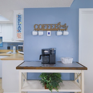 Bright and inviting kitchen corner featuring a Keurig coffee maker and cheerful beach-themed decor for a relaxing getaway