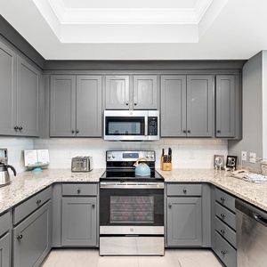 Cook and gather in this inviting kitchen with elegant cabinetry, stainless appliances, and spacious counters
