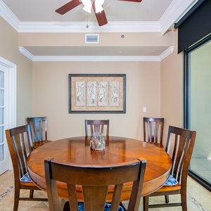 Savor heartfelt conversations at the round dining table while admiring the beach view through the large windows