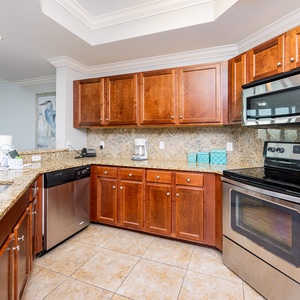 The kitchen features wood cabinets, stainless appliances, and a granite countertop, perfect for meal prep and entertaining