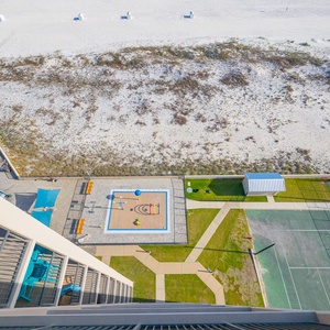 Laughter fills the air near the colorful splash pad and tennis courts just beyond your balcony view