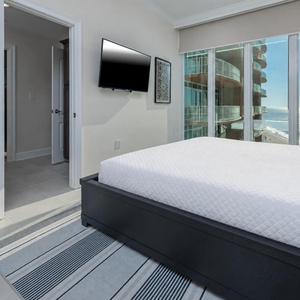 Wake to a breathtaking sunrise in this king guest suite with expansive views from the windows
