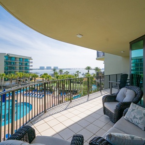 Relax on the balcony, taking in the refreshing coastal breeze and stunning views of the shimmering pool below