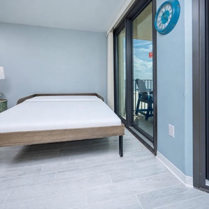 Wake up to the shoreline view in the living space with a queen murphy bed