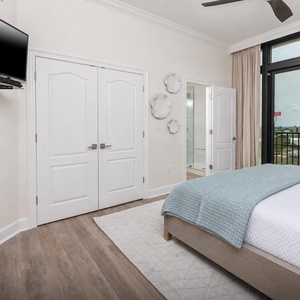 This bedroom features a cozy atmosphere with a king bed, TV, and stunning views from the large windows