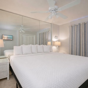 Lamp light casts a cozy glow over the king bed in the guest suite where you rest and recharge