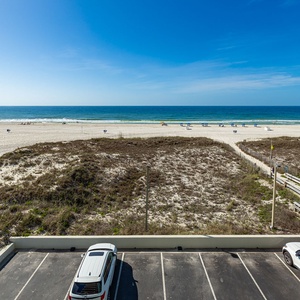Gaze at the serene beach view from your balcony as you enjoy the soothing sounds of the coast nearby
