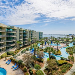 Relax on the balcony, basking in warmth while enjoying views of lush palms and glimmers of the bay