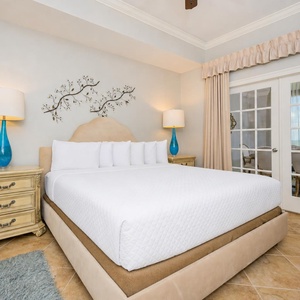 Experience restful nights in this king master suite, where comfort meets beach vibes with plush bedding and soothing decor
