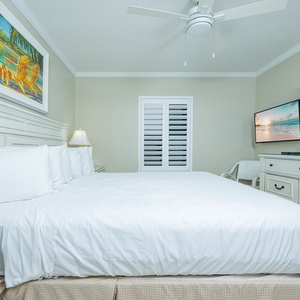 Serene guest bedroom featuring a king bed, soft linens, and coastal art for a restful night's sleep
