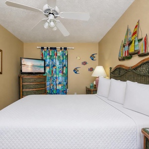 Enjoy a restful night in this guest bedroom, where soft queen bedding and coastal decor create a serene vibe