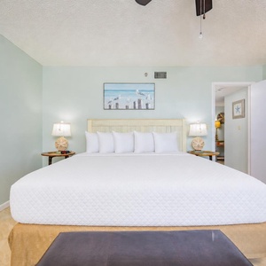 Feel refreshed in this spacious master bedroom, where soft linens promise restful nights after beach adventures