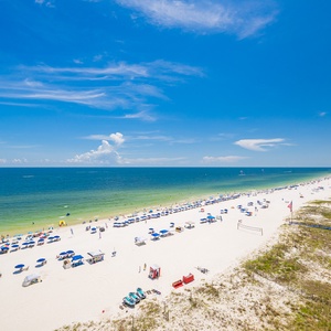 Enjoy your stay with the vibrant beach, colorful umbrellas, and clear blue waters, perfect for relaxation and fun