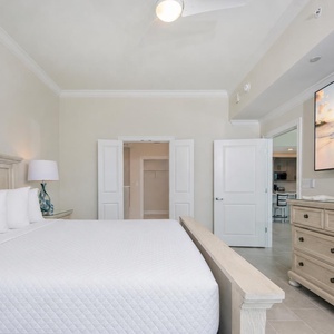 Unwind in this tranquil bedroom featuring a king bed, large TV, and coastal decor for a restful retreat
