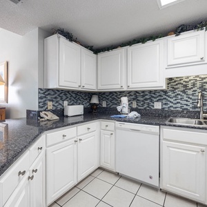 Prepare meals in this tylish kitchen, featuring sleek countertops and ample storage for your culinary needs