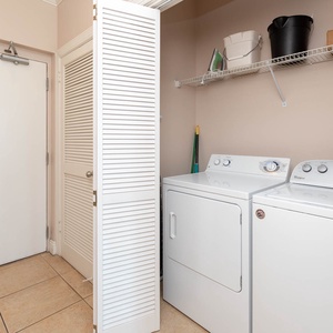 Conveniently access the laundry area featuring a washer and dryer, perfect for keeping your clothes fresh during your stay