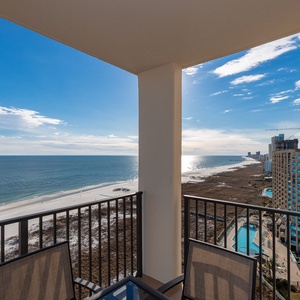 Inviting balcony view showcasing the beach, sparkling gulf waters, and the pool area below, perfect for relaxation