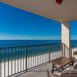 Enjoy the comfortable seating of the balcony while relaxing with expansive views of the tranquil waters and shoreline
