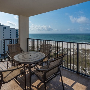 Balcony patio set for four offers a serene view of the beach, perfect for enjoying morning coffee or evening sunsets