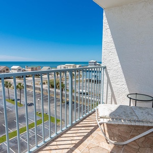 This balcony offers a stunning beach view, perfect for relaxing on the lounge chair and enjoying the sea breeze