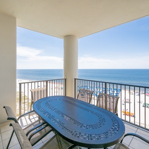 Enjoy meals and beach breezes on the spacious balcony with a stunning view of the pristine beach and blue waters