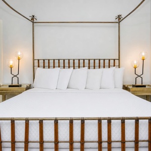 Rest in this master bedroom featuring a king bed, soft pillows, and unique lighting for a restful night's sleep