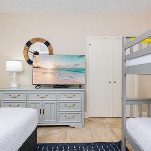 Cozy up on the plush bedding while enjoying a movie on the large TV in this guest bunk room