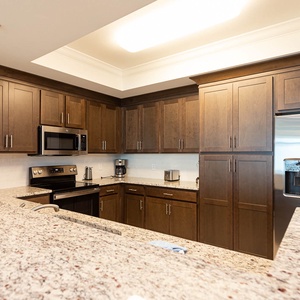 Imagine prepping breakfast at the long counter with stainless appliances and ample cabinetry