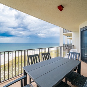 Balcony seating offers a panoramic view of the tranquil gulf and beach, perfect for enjoying the coastal breeze
