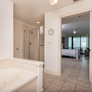 Indulge in relaxation with a spacious jetted tub, separate walk-in shower, and charming decor enhancing your bath experience