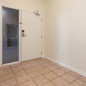 Welcoming entryway featuring tiled flooring and a clear view into the adjacent space, enhancing the sense of arrival