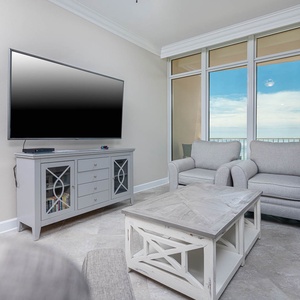 Relax in the cozy chairs as you enjoy the views and gentle sounds of the coast from your beachfront family room