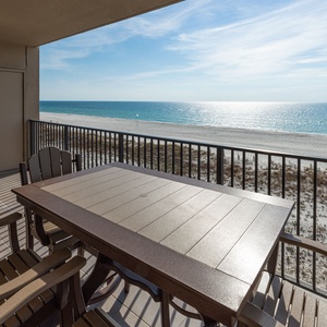 Dine at the outdoor table while enjoying the calming views of the water and beach from your comfortable seating