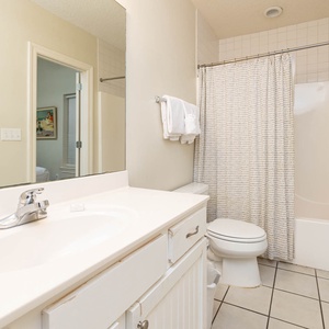 Refresh in this guest bathroom featuring a spacious vanity, soft towels, and a relaxing tub-shower combination