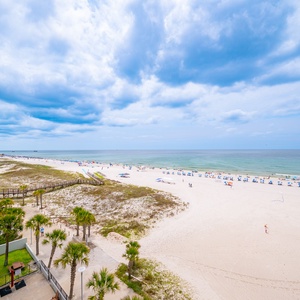 Gaze at the expansive shoreline from the balcony overlooking the Gulf Shores public beach in the heart of the city