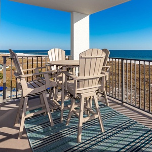 Balcony seating offers a relaxing spot to enjoy views of the gulf and surrounding landscape under a clear blue sky