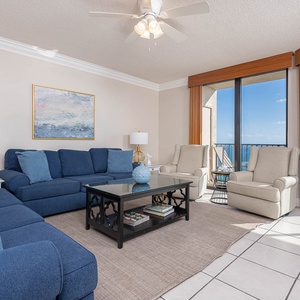Relax in the spacious living area featuring a sofa with queen sleeper and stunning beachfront balcony views