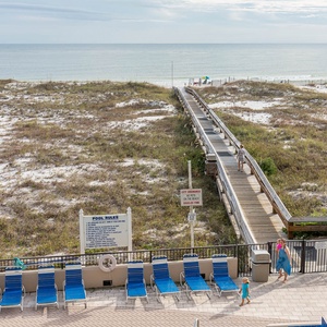 Relax by the poolside on lounge chairs, with a boardwalk leading you to the beach just steps away