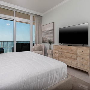Enjoy gulf breezes from the king bed in the master bedroom while balcony chairs frame the shoreline