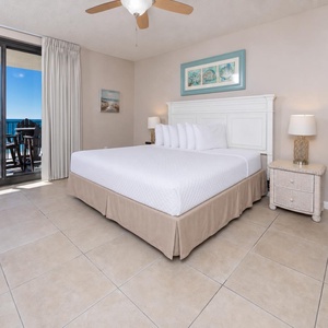 Relax in this inviting master bedroom with a comfortable king bed, vibrant decor, and beachfront balcony access