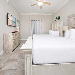 Nestle into the plush queen beds of this inviting guest room, where restful nights await after beachside excursions