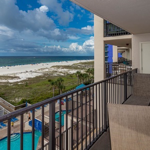 Relax on the balcony enjoying views of the beach and pool area, perfect for unwinding in the fresh gulf air